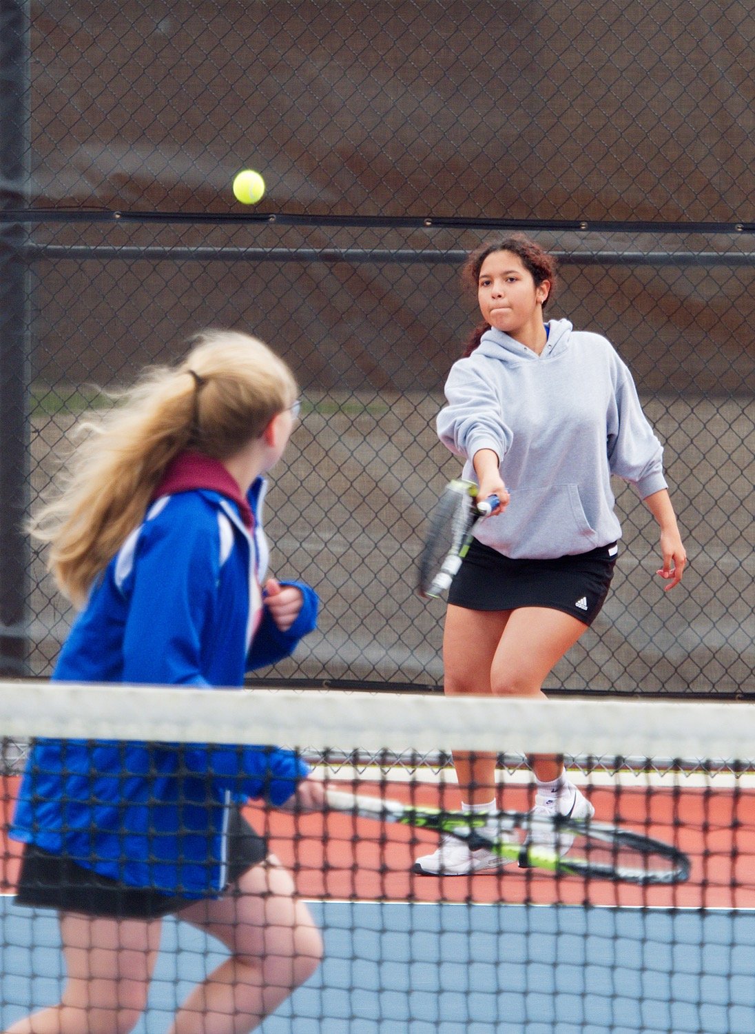 Emily Roman plays a forehand from the baseline as Tristan Wood gets in position at the net. [view more volleys]